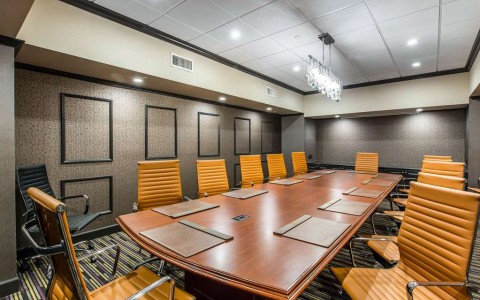 conference room with wooden table and orange chairs 