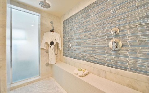 inside of large shower with robe 
