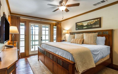 a guest room with wood french doors