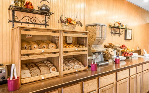 bakery items in shelves on breakfast counter by cereals and fruit