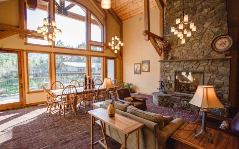 breakfast seating area in room with stone fireplace