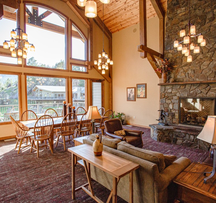 breakfast seating area in room with stone fireplace