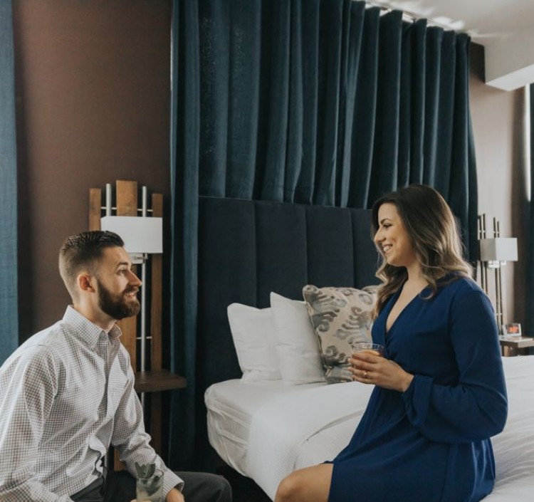couple in hotel room talking