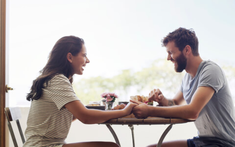couple eating and holding hands