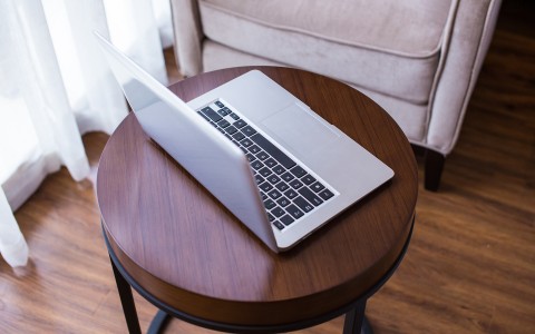 laptop on small round brown table