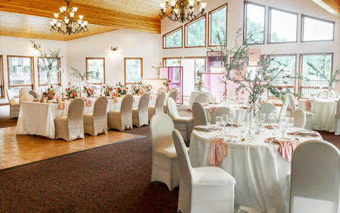 Event space set up with round tables and a dance floor