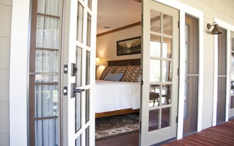 the french doors opening into a guest room