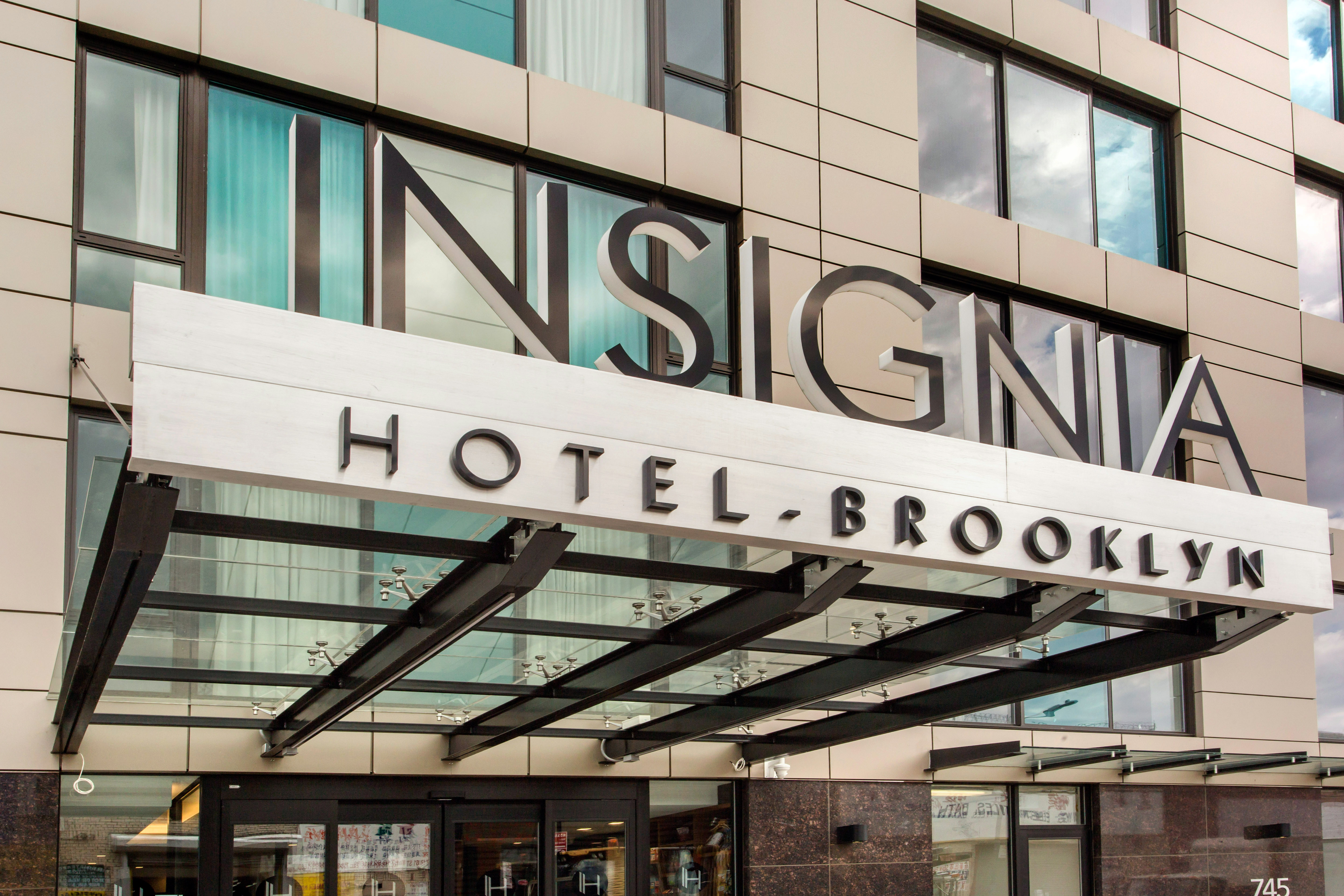 exterior of hotel with insignia sign