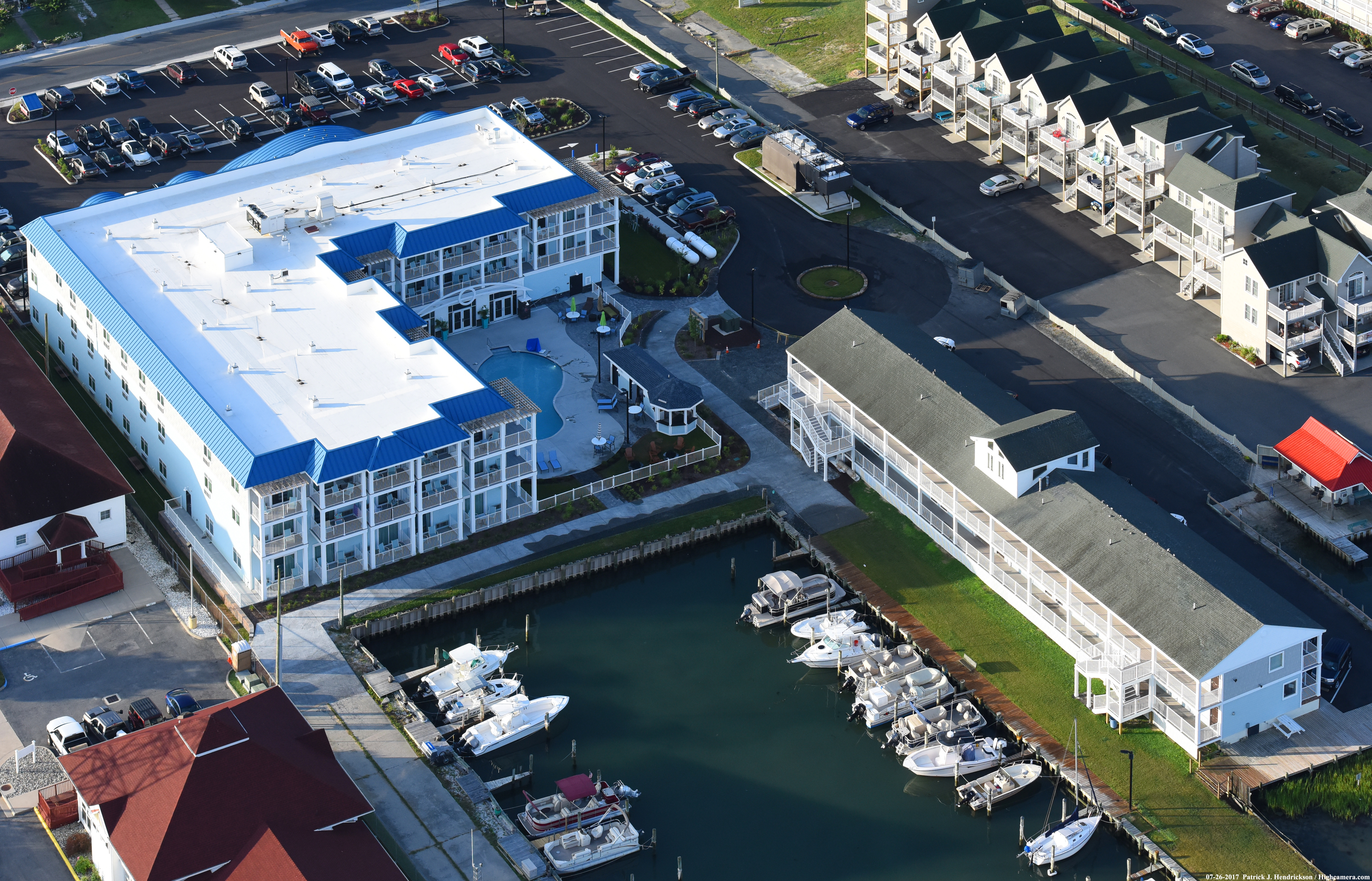 aerial image of hotel, pool and marina with docked boats