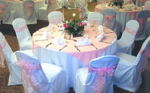round table with pink linens