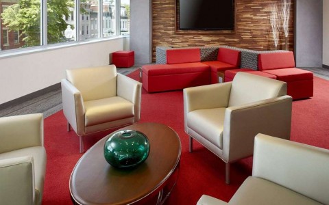 lounge area in lobby with seating and tv