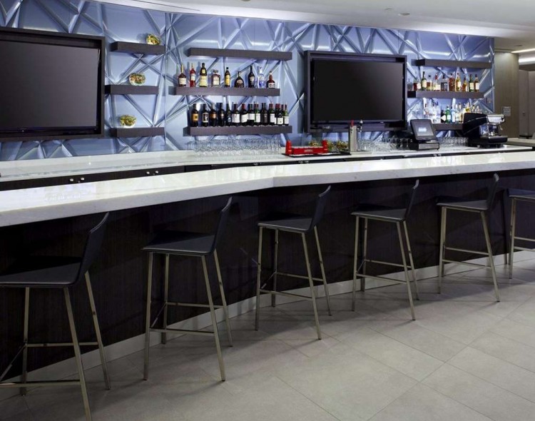 modern cocktail bar with seating and televisions