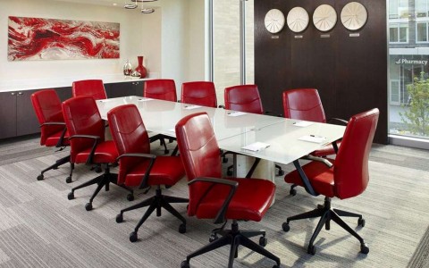 meeting room with conference table and red chairs