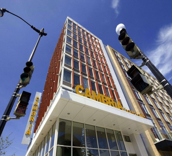 exterior of hotel in daytime looking up the building