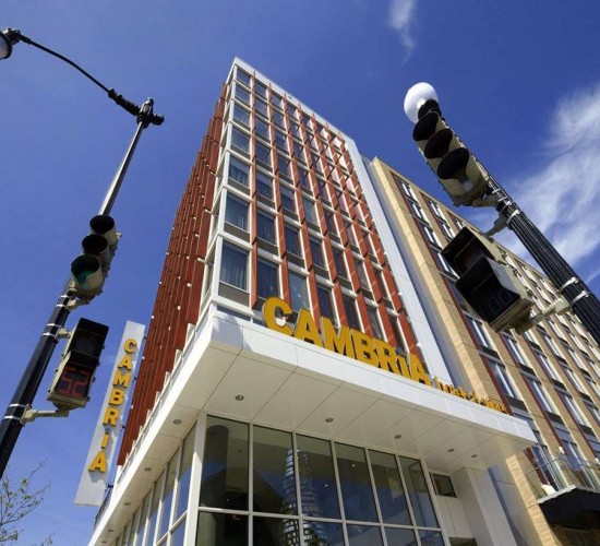 exterior of hotel in daytime looking up the building