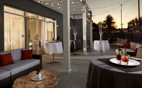 Outdoor event space with lounge seating and hightop tables