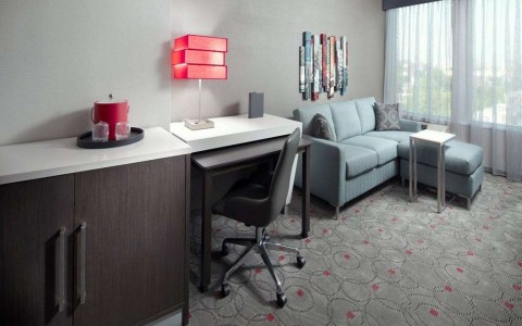 living room with sofa and desk in suite