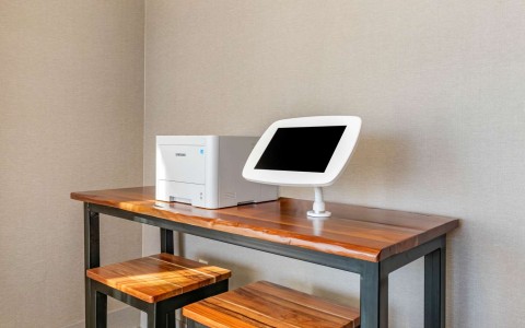 Business center with a printer and a tablet on a table