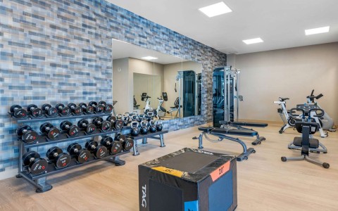 Exercise room with cardio equipment and weights
