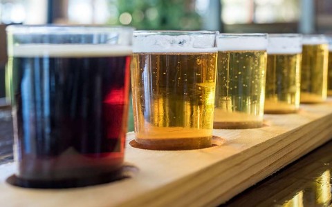 flight of different colored beer glasses