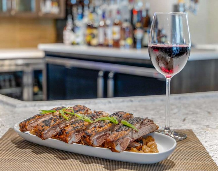 plate of ribs with a glass of red wine