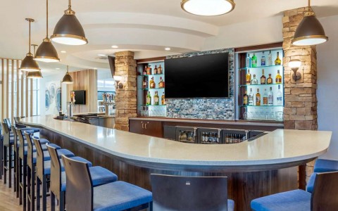 Hotel bar with seating and tv