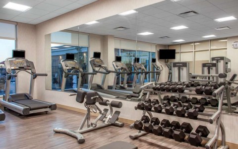 Exercise room with cardio equipment and weights