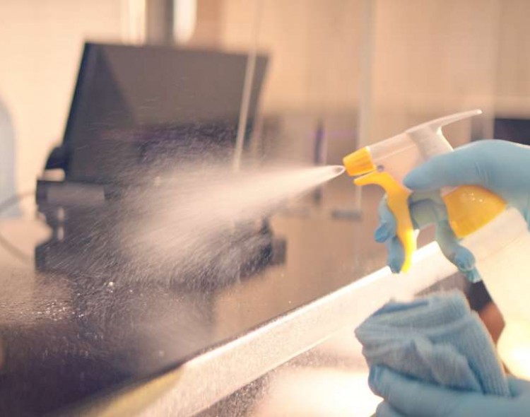 disinfectant being sprayed on counter