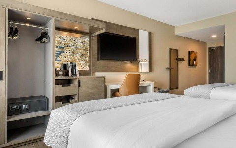 Guest room with two queen beds and tv