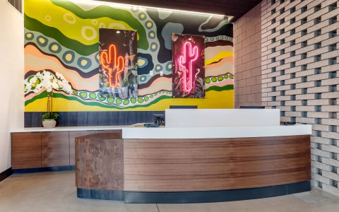 the front desk with artwork behind it