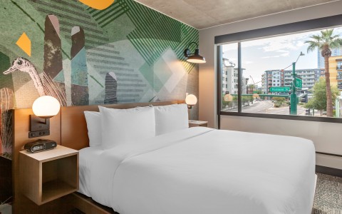 hotel room with king bed and large windows
