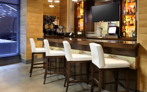 hotel bar with four barstools 