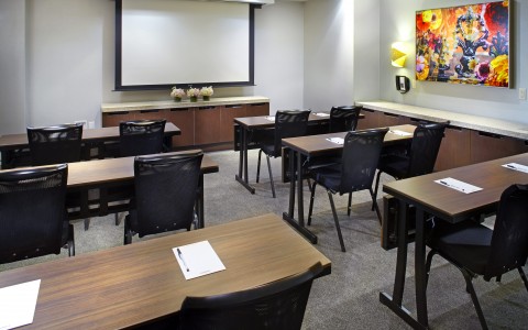 meeting room set up classroom style with projector screen