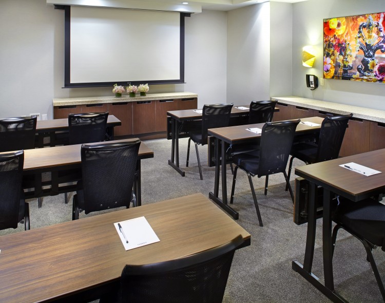meeting room set up classroom style with projector screen