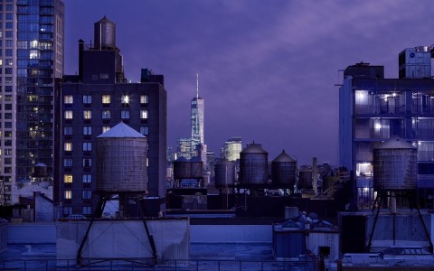 new york city skyline with one world trade center in purple sky