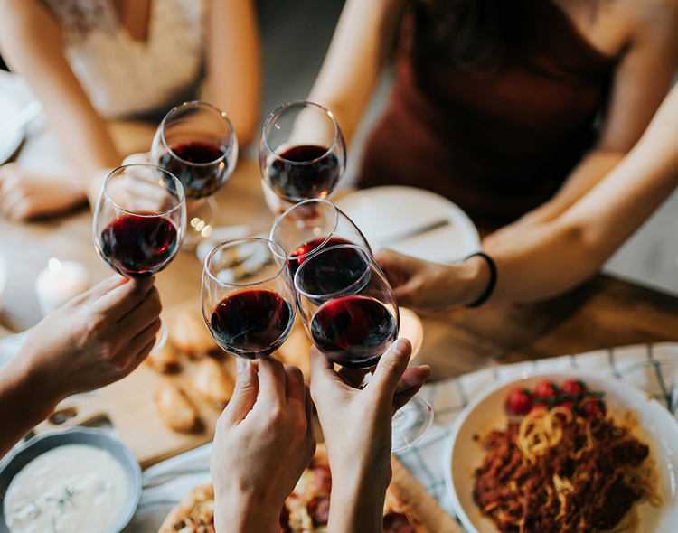 group of people toasting their glasses of wine