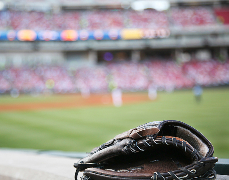 baseball glove and ball in stadium