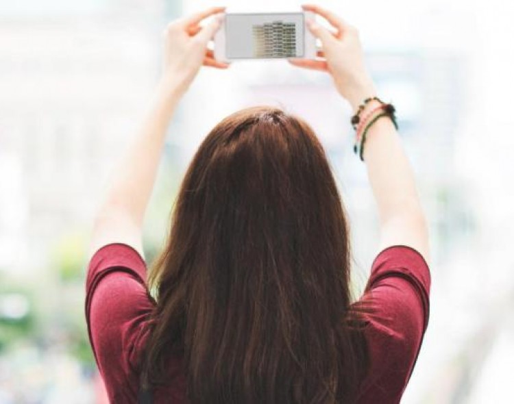 woman holding phone up