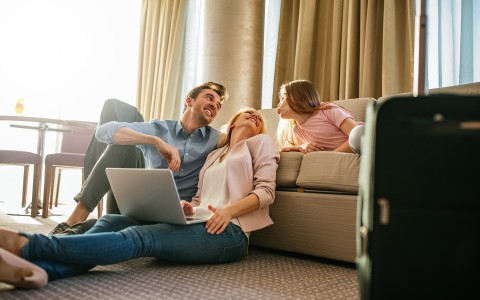 parents with daughter on couch in suite