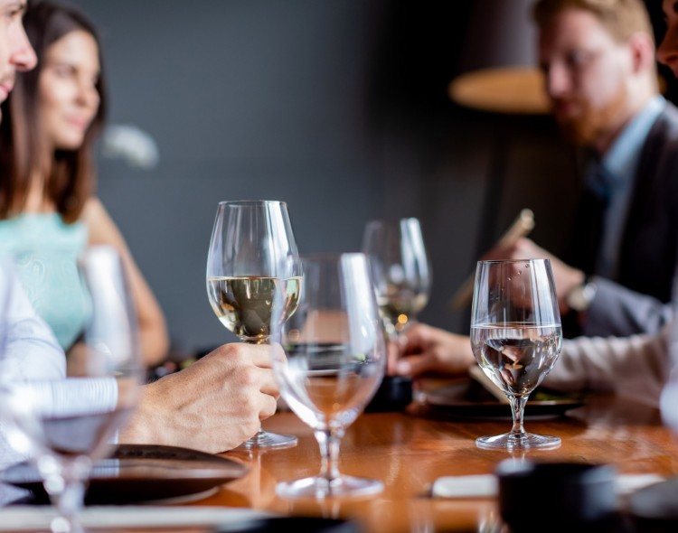 people having dinner with wine