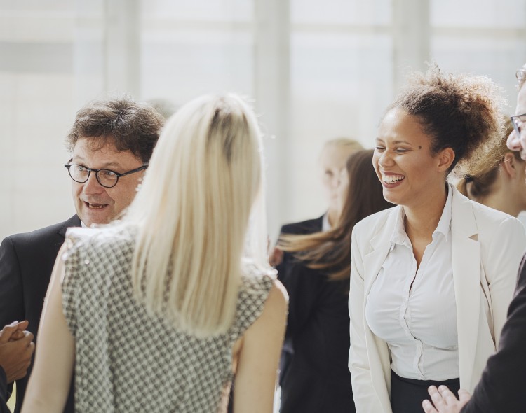 group of people in business clothes standing and talking
