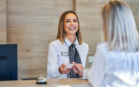 woman checking guest in