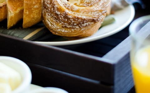 close up of pastries sitting on a white plate in a black tray
