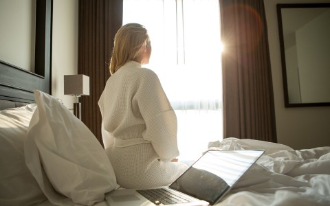 woman in a robe waking up in bed
