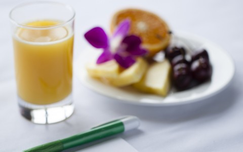 fresh fruit and a glass of orange juice