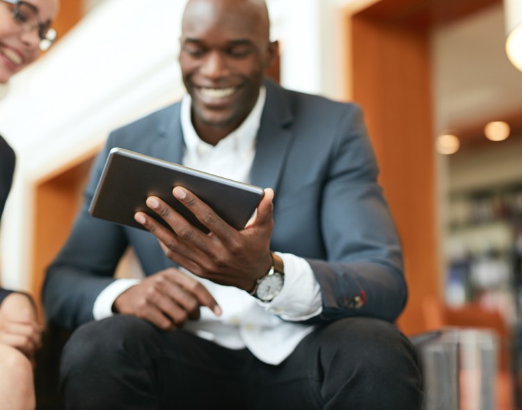 man in a suit on his tablet