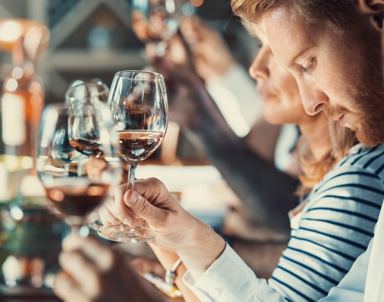 group of people tasting red wine