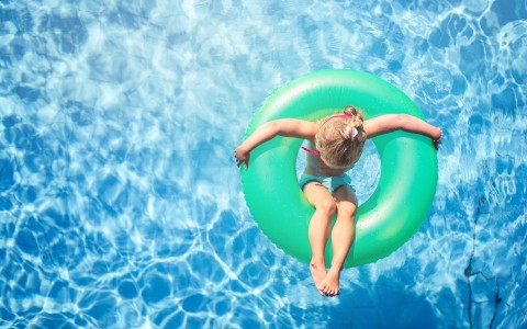 aerial view of a kid floating on a pool