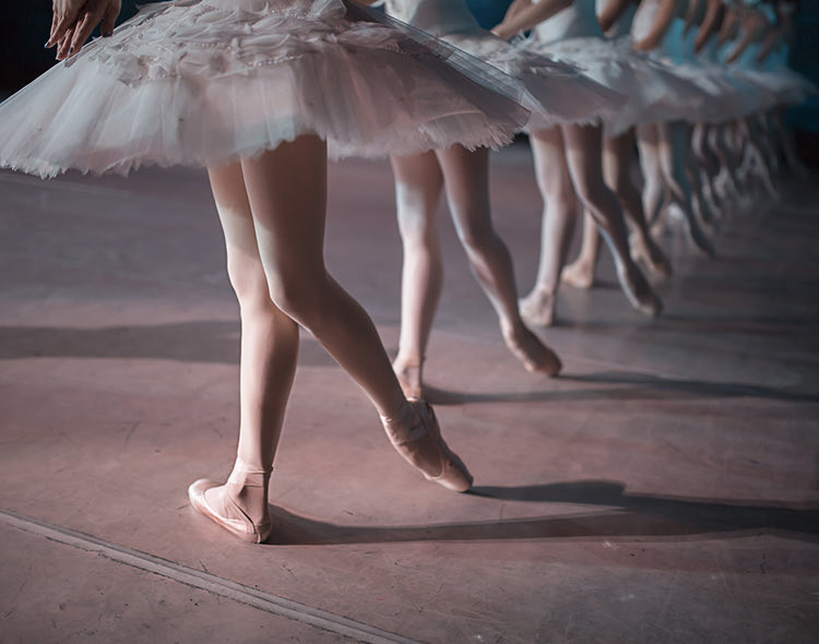 many ballerina feet on stage