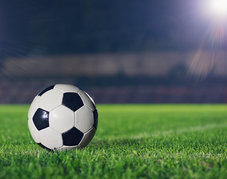 a soccer ball on a field in the dark